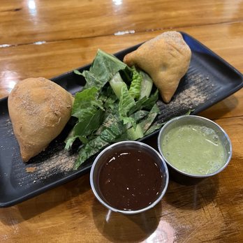 Indian Aroma - Two-piece aloo samosa with tamarind and mint chutney - Indian Near Me - Gainesville, Florida Indian Aroma - Two-piece aloo samosa with tamarind and mint chutney - Indian Near Me - Gainesville, Florida