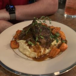The Feiring - Scrumptious braised short ribs over a red wine reduction gravy, mashed potatoes and roasted carrots.