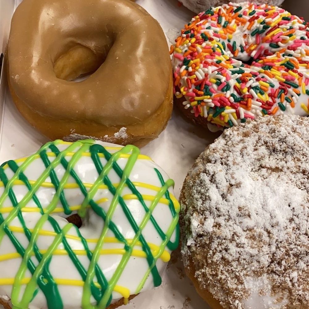 a variety of doughnuts in a box a variety of doughnuts in a box
