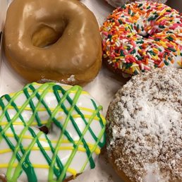 a variety of doughnuts in a box a variety of doughnuts in a box