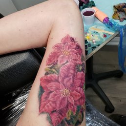 Poinsettias on my inner bicep to cover a long scar I have and TJ did an amazing job!  I love it!
