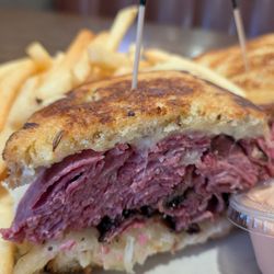 Heaping mounds of corned beef/ Pastrami, Swiss, sauerkraut,on rye toasted hot + side of real Russian dressing