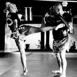 Beacon Mixed Martial Arts and Fitness - Coach Danika cracking the Muay Thai pads with a great roundhouse kick, Daddis Mixed Martial Arts Academy Cherry Hill NJ
