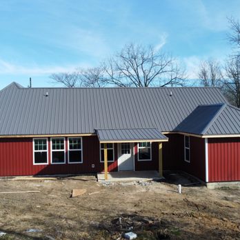 Belken’s Home Design - a red house with a metal roof - Siding Near Me Belken’s Home Design - a red house with a metal roof - Siding Near Me