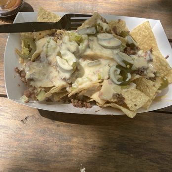 SLAB BBQ & Beer - Brisket nachos: tortilla chips piled high with queso, onions, pickles and jalapeños: - Barbeque Near Me - Austin, Texas SLAB BBQ & Beer - Brisket nachos: tortilla chips piled high with queso, onions, pickles and jalapeños: - Barbeque Near Me - Austin, Texas