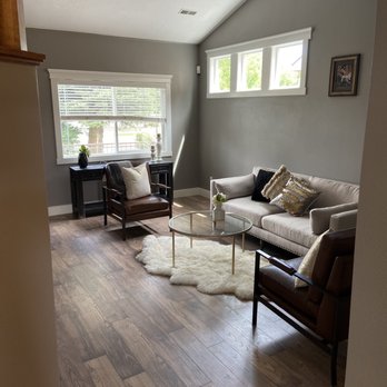 Home Service Pros - a living room with wood floors - Flooring Near Me