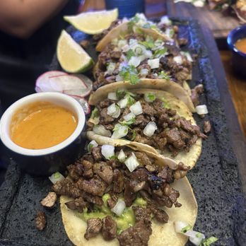 La Más Querida - Traditional Tacos (5) Mix of skirt steak and ribeye, guacamole, onion, cilantro, and radish. - Mexican Near Me - San Jose, California La Más Querida - Traditional Tacos (5) Mix of skirt steak and ribeye, guacamole, onion, cilantro, and radish. - Mexican Near Me - San Jose, California