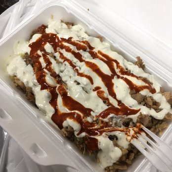 Lazeez Shawarma - a plastic container filled with sauce and meat - Mediterranean Near Me - Waterloo, Ontario