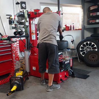 Affordable Convenient Tire Services - Brawnsen working hard installing tires!  Man did not even break a sweat! - Tires Near Me