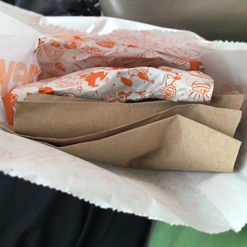 Popeyes Louisiana Kitchen - a person holding a bag of food - Chicken Wings Near Me - Edmond, Oklahoma Popeyes Louisiana Kitchen - a person holding a bag of food - Chicken Wings Near Me - Edmond, Oklahoma