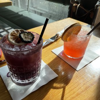 Outpost Kitchen - This drink on the left which is purple, is called the butterfly effect. And it was magnificent. - Breakfast & Brunch Near Me - Costa Mesa, California