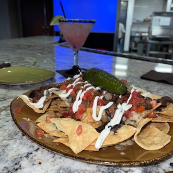 Blue Coyote Cantina - a plate of nachos and a drink - New American Near Me - Scottsdale, Arizona Blue Coyote Cantina - a plate of nachos and a drink - New American Near Me - Scottsdale, Arizona