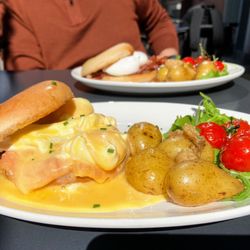 The Alehouse - Eggs Royale  poached eggs, smoked salmon, homemade hollandaise on toasted bagel, served with roasted baby potatoes and cherry tomatoes.