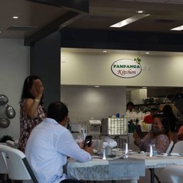 a group of people sitting at a table a group of people sitting at a table