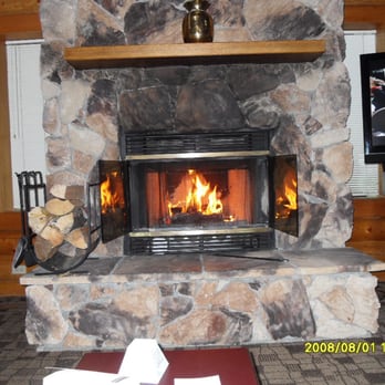 Castle Mountain Chalets - the warm cozy inviting fireplace. firewood and kindling included, extra firewood $5..but dont need it. - Hotels Near Me - Banff, Alberta