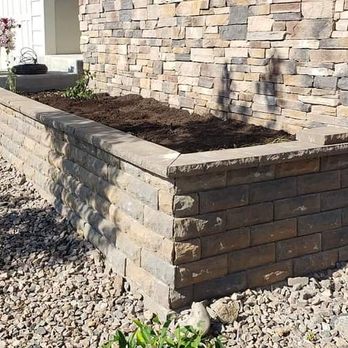 Gomez Landscaping - a brick wall with a raised planter - Landscaping Near Me Gomez Landscaping - a brick wall with a raised planter - Landscaping Near Me