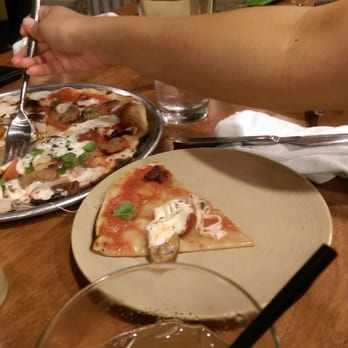 Monkeypod Kitchen - Putting the toppings back on the raw pizza. - Hawaiian Near Me - Kapolei, Hawaii
