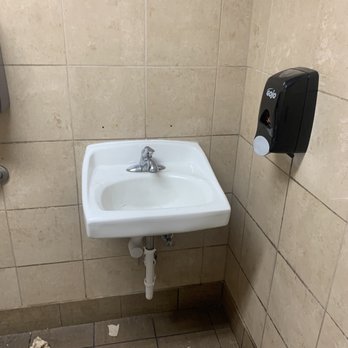 Circle K - a bathroom with a sink and toilet paper dispenser - Convenience Stores Near Me - Peoria, Arizona