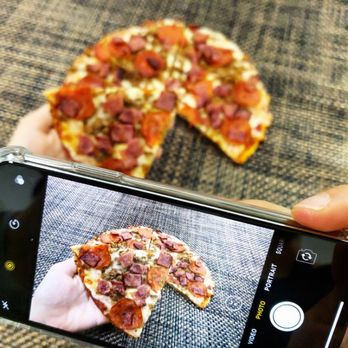 AK PREPS AND BAKERY - a person taking a picture of a slice of pizza - Food Delivery Services Near Me - Penndel, Pennsylvania AK PREPS AND BAKERY - a person taking a picture of a slice of pizza - Food Delivery Services Near Me - Penndel, Pennsylvania