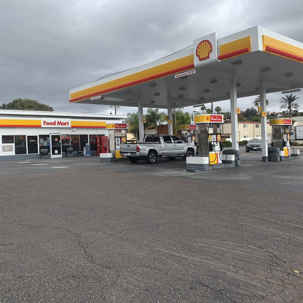 a gas station with cars parked in front of it