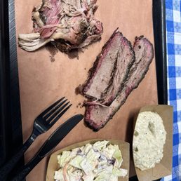 Two meat plate with jalapeño grits and coleslaw; won't disappoint! Two meat plate with jalapeño grits and coleslaw; won't disappoint!