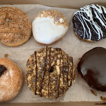 North Fork Doughnut - Upclose: jelly, banana nut with chocolate chips, Boston cream, cookies and cream, apple crumb, and caramel coffee crumb - Donuts Near Me - Mattituck, New York