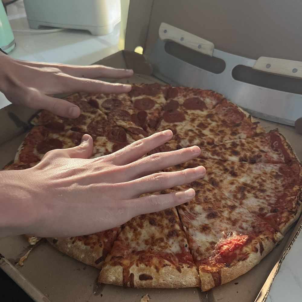 This is a picture of the "XL" pizza I ordered, next to the hands of a 14 year old. This is a picture of the "XL" pizza I ordered, next to the hands of a 14 year old.