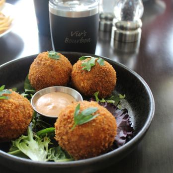 Covey Kitchen + Cocktails - Reuben Croquette ($12) braised short rib combined with sauerkraut and gruyere rolled into balls and deep fried served with house 1000 island - Cocktail Bars Near Me - Gainesville, Florida Covey Kitchen + Cocktails - Reuben Croquette ($12) braised short rib combined with sauerkraut and gruyere rolled into balls and deep fried served with house 1000 island - Cocktail Bars Near Me - Gainesville, Florida