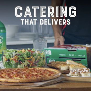 Marco's Pizza - a table with a pizza and salad - Pizza Near Me - Crossville, Tennessee