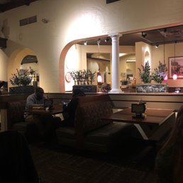 people sitting at tables in a restaurant