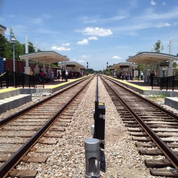 Sand Lake Road Sunrail Station - A look down the empty tracks. - Train Stations Near Me - Pine Castle, Florida Sand Lake Road Sunrail Station - A look down the empty tracks. - Train Stations Near Me - Pine Castle, Florida