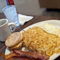 Russell's Restaurant - Russell's breakfast, two eggs over easy hash browns with cream cheese and other cheeses and black label bacon.
