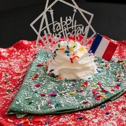 French Crêperie - Joyeux Anniversaire - Free Birthday Crêpe - Colorful Crêpe filled with your choice of French jam and topped with whipped cream.