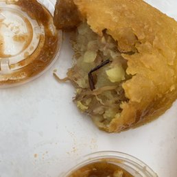 An empanada de carne with a roach leg.