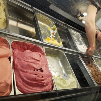 Glaces Dolce Gelato - a woman selecting gelato flavors - Ice Cream & Frozen Yogurt Near Me - Quebec City, Quebec