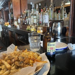 a plate of fries and a bottle of beer