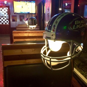 Wallbangers Burger Bar - In the sports bar section there are football helmet lamps. The dining room is a mix of sports bar (TV screens) and movie pop nostalgia - Burgers Near Me - McAllen, Texas