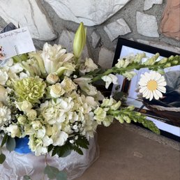 A white floral arrangement for condolences/loss