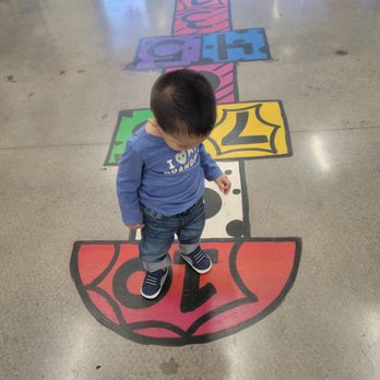 D’s Silly Kids Cuts - Ariel view of my son's fresh cut, whilst he admires the floor art. - Kids Hair Salons Near Me - Lancaster, California