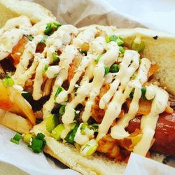 Flavors of Cali - Tyler- Double Beef Bulgogi Hot Dog topped with Kimchi Green Onions Sesame Seeds and a Sriracha Crema