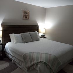 Goose Pond Inn B & B - Room 1, Sleeping Bear, includes king size adjustable bed, two sitting chairs, a table, a dresser, and an ensuite bathroom