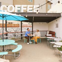 The Coffee Drop - Shop outdoor patio with tables + chairs and WiFi 2026 The custom mural by Panca in the back, as well as