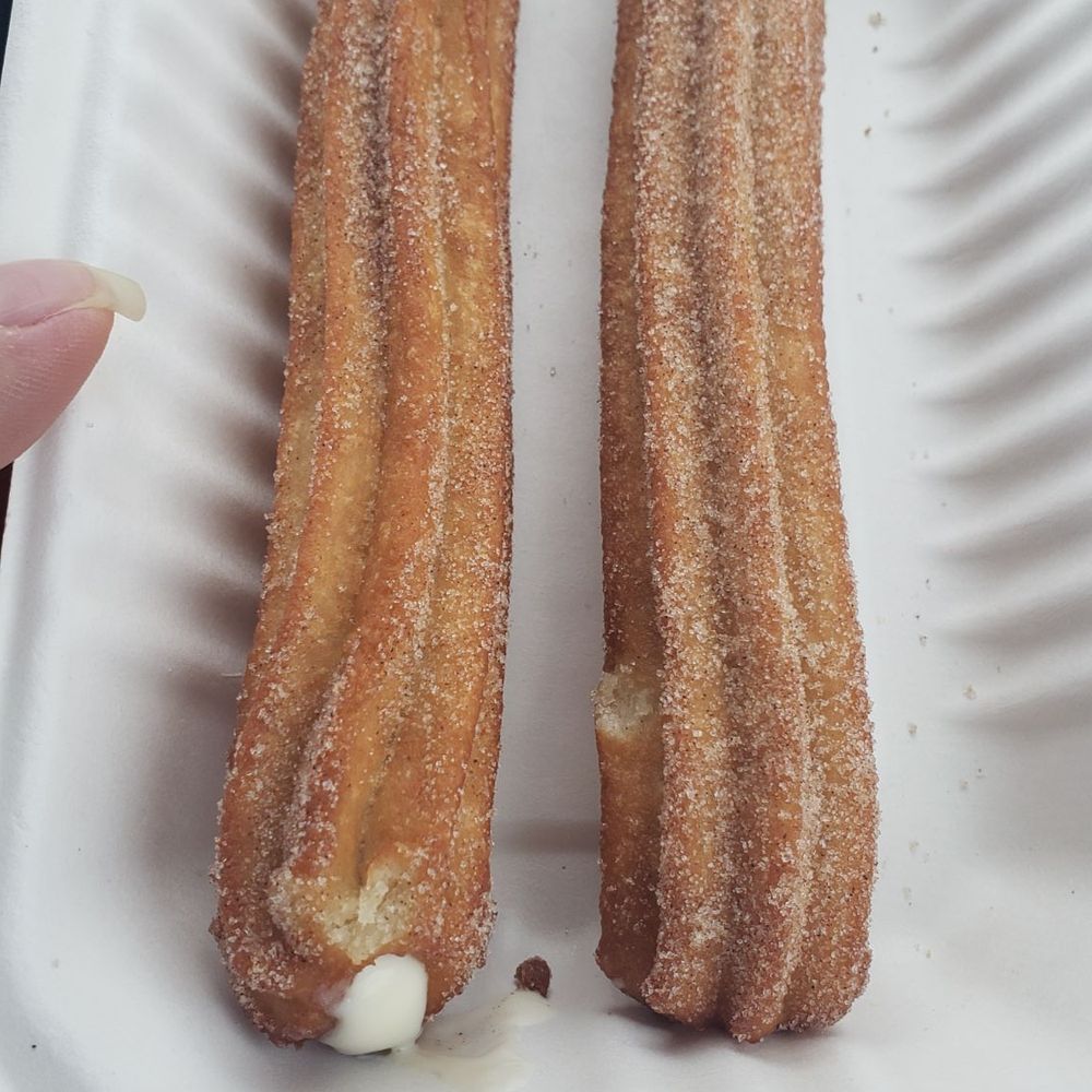two donuts in a styrofoam container two donuts in a styrofoam container