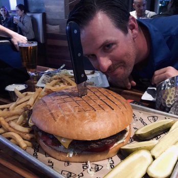Topgolf - 40 oz. burger (head for scale) - New American Near Me - Orlando, Florida Topgolf - 40 oz. burger (head for scale) - New American Near Me - Orlando, Florida