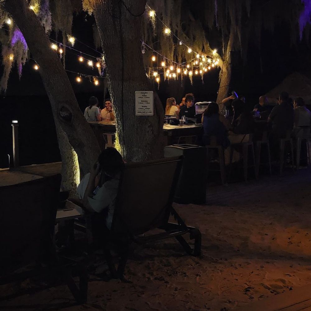 Port 27 - There was a DJ playing near the lake, music floating across the water. The bar sits right on the waterfront. - Burgers Near Me - Haines City, Florida