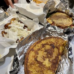 Patacon Pisao - [clockwise] yuca frita; blt patacon; cachapa de pabellón; maduros