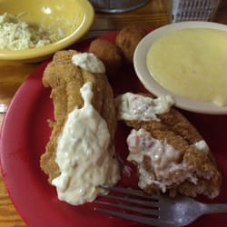 David's Catfish House - Coleslaw was served as a salad before the meal; two catfish filets, cheese grits, hushpuppies.