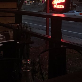 Spark Pizza - Pretty view on the deck with patio lights and the glow from the neon sign - Pizza Near Me - Redmond, Washington