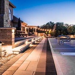 Creekside Outdoor Living - Summer nights on a backyard paver pool deck