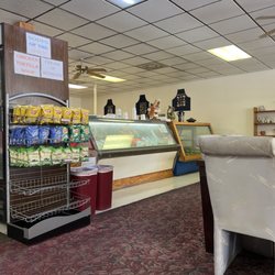 Greengrocers Deli & Gourmet Shop - Salad counter, cooler and chip rack. Seating area to the right and behind us.